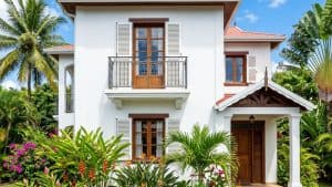 Villa blanche tropicale avec balcon et palmiers